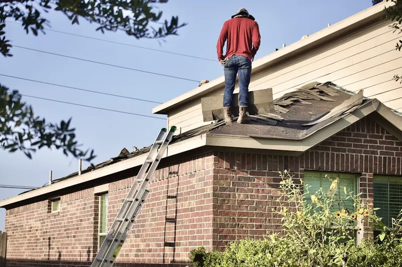 Professional roofer working on a residential roof in Cape May Point